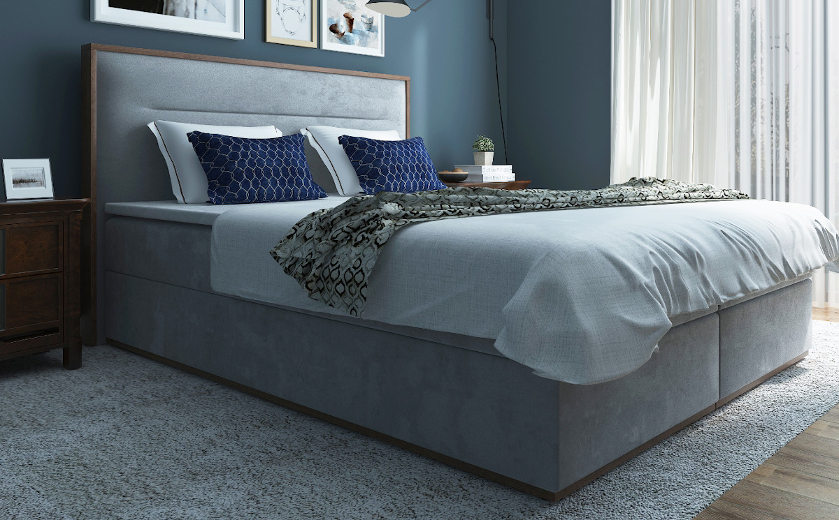 Łóżko kontynentalne z tapicerowanym wezgłowiem otoczonym drewnianą ramą